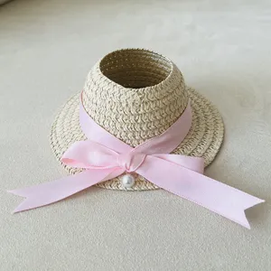 Mini woven straw hat doll accessory with pink ribbon bow and pearl detail for plush toys.