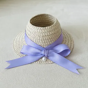 Miniature woven straw hat for dolls, cute purple ribbon bow and pearl decor accessory.