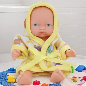 Detailed view of the 5.5-inch cute baby doll wearing a yellow hooded bathrobe, ideal as a gift.
