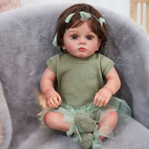 Detailed shot of reborn baby doll, 22-inch silicone vinyl doll with green knitted outfit.
