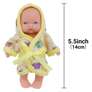 Close-up detail of 5.5 inch cute baby doll wearing yellow hooded bathrobe and ribbon.