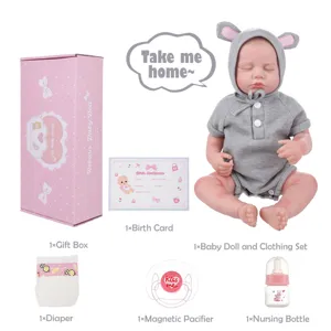Reborn doll set detail featuring realistic vinyl newborn infant with grey outfit and accessories.