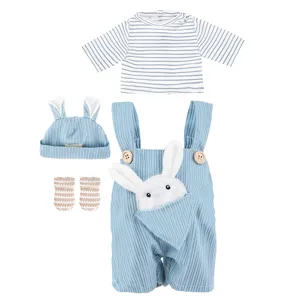 Detailed view of cute blue corduroy doll overalls set with striped top, hat, and bunny pocket.