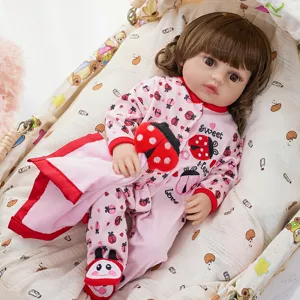 Detail of cute reborn baby doll wearing pink ladybug onesie and matching cute shoes.