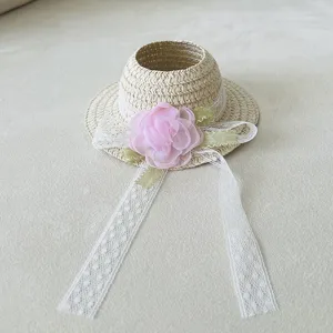 Mini straw hat doll accessory with pink flower and lace ribbon for cute toy dress up.