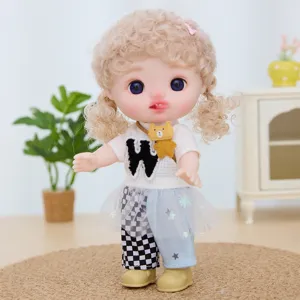 Detailed view of 9-inch vinyl dress-up doll with curly hair, cute outfit and movable joints.
