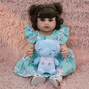 Detailed view of a cute reborn baby doll with curly brown hair wearing a unicorn dress.
