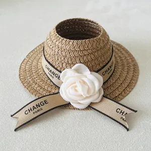 Woven straw sun hat for doll accessory, cute beige hat with white flower and ribbon.
