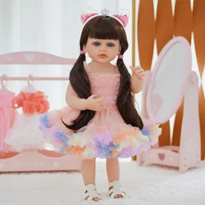Detailed view of cute reborn baby doll in pink dress with cat ear headband and lovely doll room.