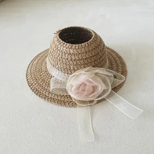 Miniature woven straw sun hat detail featuring a organza ribbon for cute doll accessory.