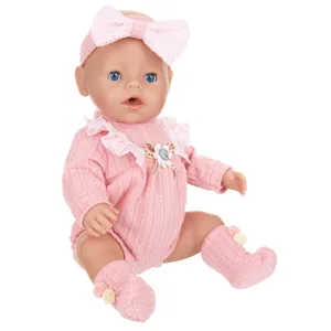 Detailed view of the pink knitted doll outfit set, including headband and cozy socks.