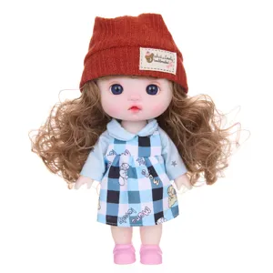 Cute 9-inch vinyl doll toy with movable joints, brown knitted hat and blue plaid dress.