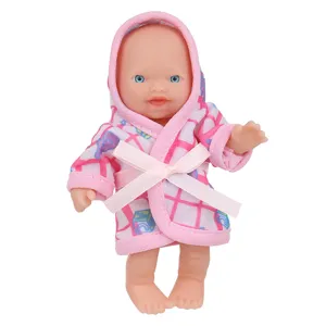 Close-up of 5.5-inch cute baby doll wearing a pink plaid hooded bathrobe with bow detail.