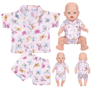 Doll pajama set detailed view, pink butterfly print short sleeve top and matching shorts.