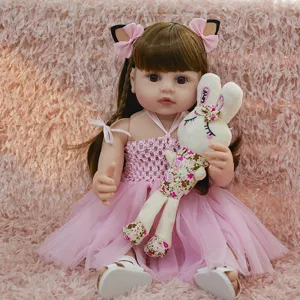 22 inch reborn baby doll vinyl simulation infant toy with pink dress and rabbit toy.