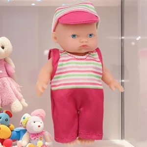 Detail view of 5.5 inch cute baby doll wearing striped romper and matching hat in display.