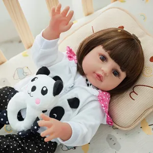 Detailed close-up view of a 45cm reborn baby doll with cute vinyl face, panda toy and polka dot outfit.