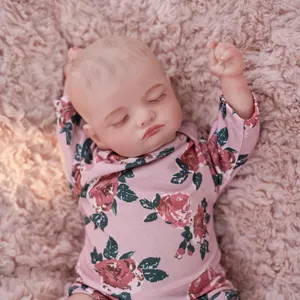 Detailed view of 45cm reborn baby doll with floral romper, realistic vinyl sleeping toy.