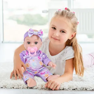 12-inch vinyl reborn baby doll with cute purple planet outfit, headband and pacifier lifestyle.