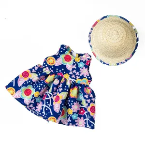 Close-up detail of 18-inch doll floral dress and straw hat set, bright summer style.