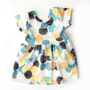 Detailed close-up of 18-inch doll dress with colorful dot and grid pattern fabric.
