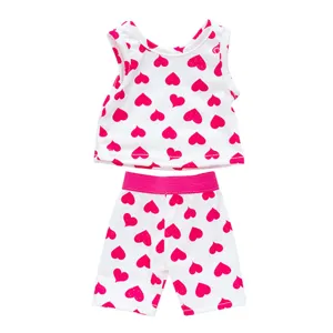 Detailed view of 18 inch doll clothing set, white top and pink heart pattern shorts.
