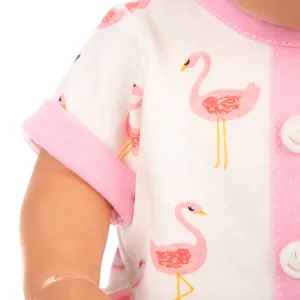 Close-up detail of doll romper sleeve, pink and white flamingo print fabric with cute smiley button.