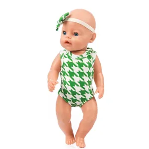 Detailed shot of a 43cm baby doll wearing a stylish green and white houndstooth outfit and headband.