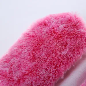 Detailed view of hot pink plush doll clothing fabric, soft and fluffy texture detail.