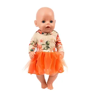 Detailed view of doll clothes featuring a floral long-sleeve top and bright orange skirt.