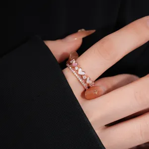 Rose gold double layer heart ring with mother of pearl and sparkling zirconia detail close up.