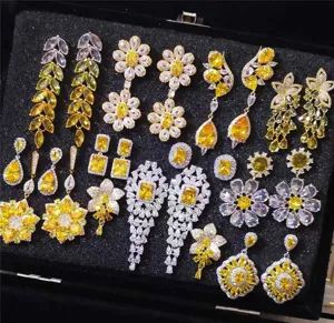 Close-up detail of luxury yellow zircon crystal flower earrings, sparkling rhinestone stud collection.