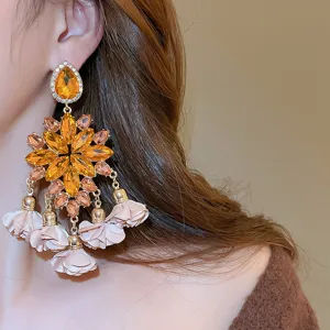 Close-up detail shot of the gorgeous yellow zircon and fabric flower tassel earrings.