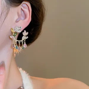 Luxury crystal flower dangle earrings with colorful zircon stones. Elegant jewelry detail.