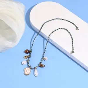 Bohemian braided shell pearl anklet detail, summer beach vacation letter foot jewelry style.