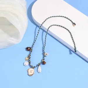Bohemian woven pearl shell anklet with letter K pendant, perfect for summer beach vacation.