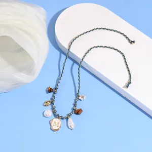 Bohemian braided anklet with pearl, shell charms and initial M pendant for summer beach vacation.