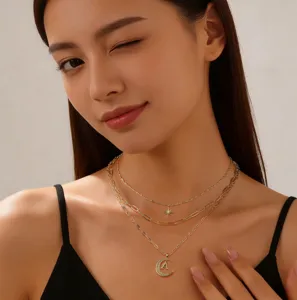 Detail view of multi-layer gold layered necklace with diamond star and moon letter A pendant.