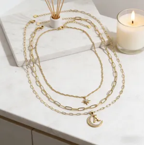 Layered gold paperclip chain necklace with star rhinestone moon letter A pendant chic jewelry.