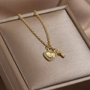Closeup detail of gold heart lock pendant necklace sparkling rhinestones letter A design.
