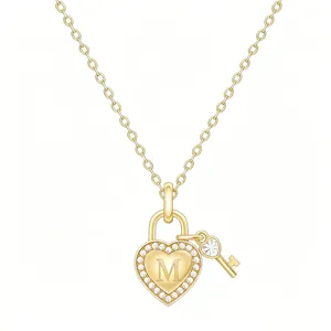 Gold heart lock key pendant necklace with crystal rhinestones and initial letter M detail.