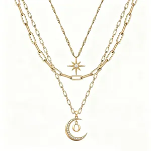 Multi-layer gold layered necklace set featuring star and moon pendants with crystal details.