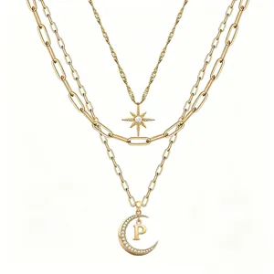 Multi-layer gold tone chain necklace featuring star and moon diamond pendants with letter P.