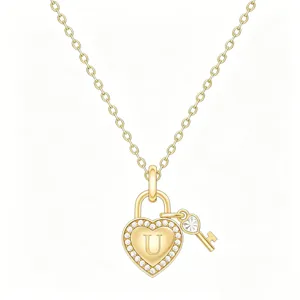 Close-up detail of gold heart padlock necklace with crystal pave and letter U pendant.