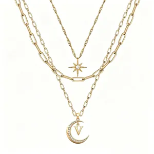 Multi-layer gold tone necklace with crystal star and moon pendant, fashion jewelry.