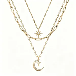 Detailed view of multi-layer layered gold necklace featuring star and moon charms with letter Y.
