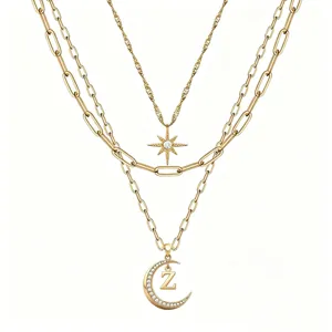 Multi-layer gold chain necklace with sparkling star and rhinestone moon letter Z pendant.
