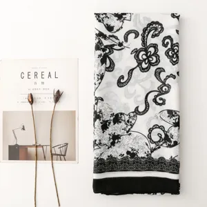 Close-up detail view of a French retro black and white floral print cotton scarf.