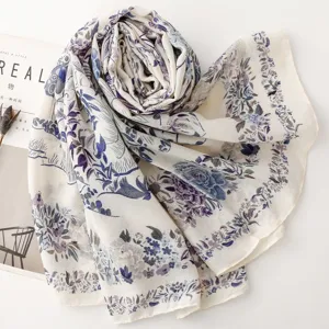 Detailed view of French pastoral floral and bird printed scarf, elegant blue and purple details.