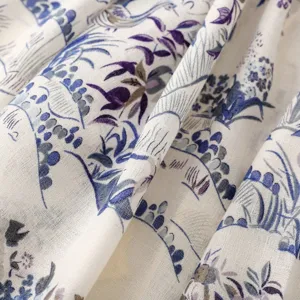 Close-up detail shot of French pastoral bird and flower print scarf, soft texture.